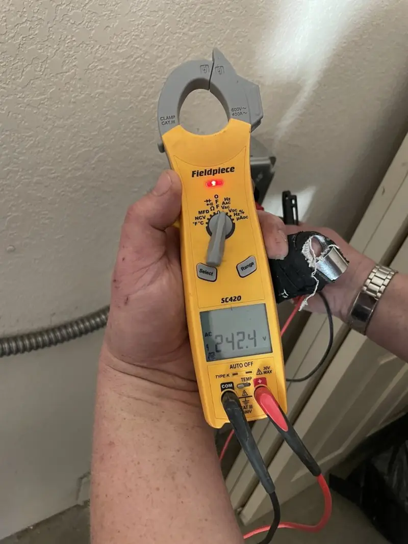 Voltage testing with clamp meter during Whole House Surge Protector in Taos